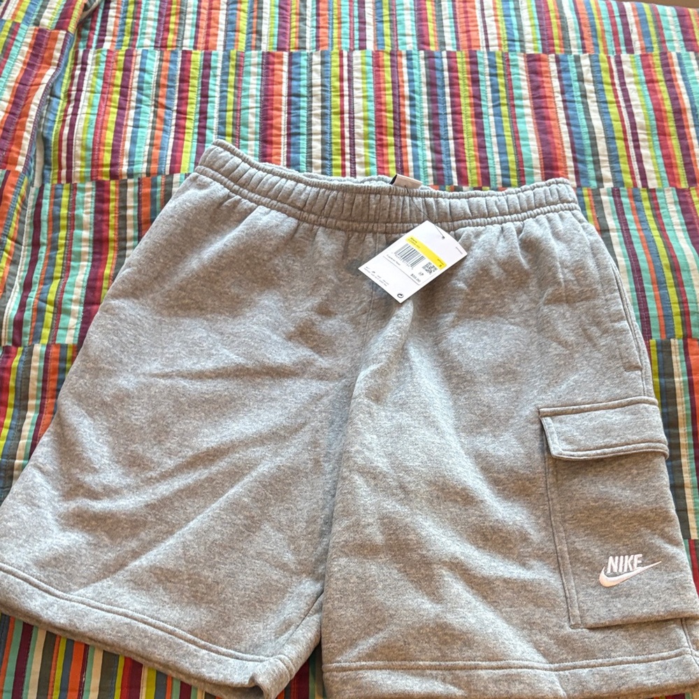 Nike  Light Gray Cargo Shorts size small new has hole on the top backside